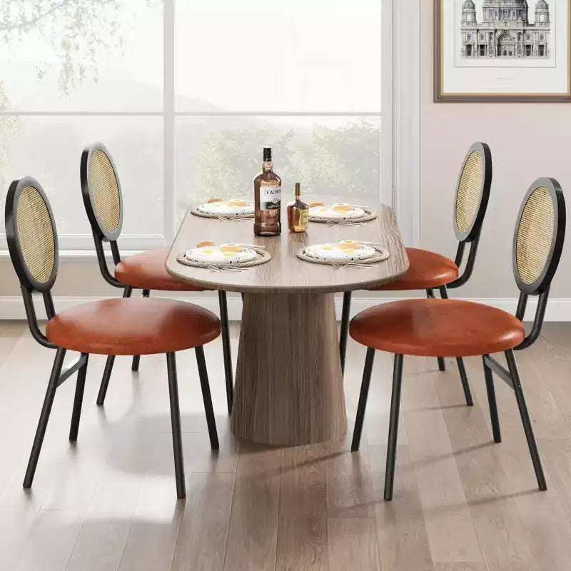 Modern upholstered dining chairs  Contemporary set with natural rattan backrest, metal legs  Space-saving design for dining room